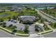 Aerial view of community pool, clubhouse, parking, and surrounding neighborhood at 2612 Canyon Crest Dr, Lakeland, FL 33811