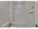 Well-lit bathroom featuring a shower-tub combination, shelving, and a clean white design at 2612 Canyon Crest Dr, Lakeland, FL 33811