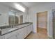 Primary bath featuring a double vanity with granite countertop, and a glass-enclosed shower at 2612 Canyon Crest Dr, Lakeland, FL 33811