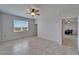 Comfortable bedroom with ceiling fan, natural light, and view into the dining room at 2612 Canyon Crest Dr, Lakeland, FL 33811