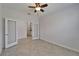 Spacious bedroom featuring double doors, neutral paint, and tile flooring at 2612 Canyon Crest Dr, Lakeland, FL 33811