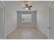 Bedroom with tile floors, neutral paint, a ceiling fan and a window bringing in natural light at 2612 Canyon Crest Dr, Lakeland, FL 33811