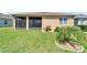 Exterior view of the home featuring a screened lanai and landscaped backyard at 2612 Canyon Crest Dr, Lakeland, FL 33811