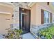 Stylish front entrance with stone accents, a decorative screen door, and manicured landscaping at 2612 Canyon Crest Dr, Lakeland, FL 33811