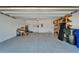 Spacious garage with storage shelving, painted floor and garage door at 2612 Canyon Crest Dr, Lakeland, FL 33811