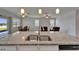 Kitchen island featuring a stainless steel sink, granite countertops, and an open view of the living space at 2612 Canyon Crest Dr, Lakeland, FL 33811