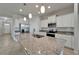 Bright kitchen features granite countertops, stainless steel appliances, pendant lighting, and white cabinetry at 2612 Canyon Crest Dr, Lakeland, FL 33811