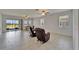 Bright living room featuring tiled floors, sliding glass doors to the patio, and comfortable seating at 2612 Canyon Crest Dr, Lakeland, FL 33811