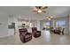 Spacious living room with tiled floors, ceiling fans, and views of the adjacent kitchen and dining area at 2612 Canyon Crest Dr, Lakeland, FL 33811