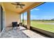 Screened-in patio with a beautiful view of the lawn and a small pond in the distance at 2612 Canyon Crest Dr, Lakeland, FL 33811