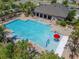 Aerial view of the community pool featuring splash pad, lounge chairs, and landscaping at 2612 Canyon Crest Dr, Lakeland, FL 33811