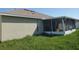 Home exterior featuring a screened porch with backyard at 451 Peace Ct, Kissimmee, FL 34759