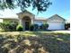 Charming single-story home with well-maintained landscaping and a two-car garage at 451 Peace Ct, Kissimmee, FL 34759