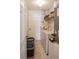 Functional laundry room with washer, dryer, shelving, and tile flooring at 451 Peace Ct, Kissimmee, FL 34759