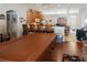 Living room next to open kitchen with wooden cabinets, and laminate flooring at 451 Peace Ct, Kissimmee, FL 34759