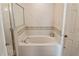 A soaking tub in main bathroom with tiled wall and floor at 451 Peace Ct, Kissimmee, FL 34759