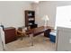 Office space featuring a large desk, bookcase, and carpeted floor at 451 Peace Ct, Kissimmee, FL 34759