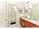 Bathroom features double sinks with granite countertops and a bathtub with white tile surround at 5247 Wildwood Way, Davenport, FL 33837