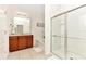 Bathroom featuring double vanity, tile floors, and glass shower doors at 5247 Wildwood Way, Davenport, FL 33837