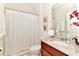 Bathroom with granite vanity, updated toilet and shower with white curtain at 5247 Wildwood Way, Davenport, FL 33837