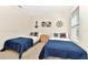 Bright bedroom featuring two twin beds, nautical themed decor and bright blue blankets at 5247 Wildwood Way, Davenport, FL 33837