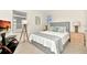 Bright bedroom with neutral carpet, gray headboard, and white and gray bedding, plus TV and decor at 5247 Wildwood Way, Davenport, FL 33837