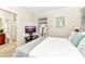 Bright bedroom with neutral carpet, gray headboard, and white and gray bedding, and view to the bathroom at 5247 Wildwood Way, Davenport, FL 33837