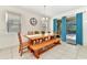 Cozy dining area featuring a wooden table, bench, and plenty of natural light at 5247 Wildwood Way, Davenport, FL 33837