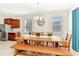Inviting dining room with a long wooden table, bench, and modern light fixture at 5247 Wildwood Way, Davenport, FL 33837