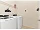 The laundry room features a front loading washer and dryer with a wire shelf at 5247 Wildwood Way, Davenport, FL 33837
