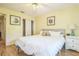 Bright bedroom features wood floors, light walls, closet and view to the adjacent bathroom at 9345 Se 171St Le Flore Ln, The Villages, FL 32162