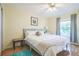 Bright bedroom features wood floors, light walls, and a large window overlooking the yard at 9345 Se 171St Le Flore Ln, The Villages, FL 32162