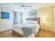 Bright bedroom features a wicker bedframe, light walls, and hardwood floors at 9345 Se 171St Le Flore Ln, The Villages, FL 32162