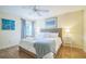 Bright bedroom features a wicker bedframe, light walls, and hardwood floors at 9345 Se 171St Le Flore Ln, The Villages, FL 32162