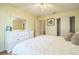 Bright bedroom boasts light walls, wood floors, and a large dresser with a mirror at 9345 Se 171St Le Flore Ln, The Villages, FL 32162
