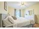 Bright bedroom features light walls, hardwood floors, and a large dresser with a mirror at 9345 Se 171St Le Flore Ln, The Villages, FL 32162