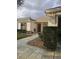Inviting single-story home with manicured landscaping and a stone walkway to the front door at 9345 Se 171St Le Flore Ln, The Villages, FL 32162