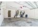 Spacious garage with concrete floor, mechanicals and access door at 9345 Se 171St Le Flore Ln, The Villages, FL 32162