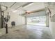 Spacious garage with concrete floor and open overhead door to exterior at 9345 Se 171St Le Flore Ln, The Villages, FL 32162