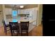 Well-lit kitchen featuring white cabinets, stainless steel appliances, and a breakfast bar island at 9345 Se 171St Le Flore Ln, The Villages, FL 32162