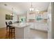 Bright kitchen featuring an island with bar seating and modern white appliances at 9345 Se 171St Le Flore Ln, The Villages, FL 32162