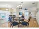 Open-concept living area with kitchen, living, and dining room visible, and hardwood floors at 9345 Se 171St Le Flore Ln, The Villages, FL 32162
