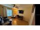 Comfortable living room with a ceiling fan, desk, and a large window for plenty of natural light at 9345 Se 171St Le Flore Ln, The Villages, FL 32162