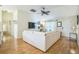Spacious living room with hardwood floors, a large sectional sofa, and easy access to other living spaces at 9345 Se 171St Le Flore Ln, The Villages, FL 32162