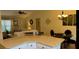 Open-concept dining and living area featuring a dining table, chandelier and comfortable sofa at 9345 Se 171St Le Flore Ln, The Villages, FL 32162