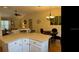 Open-concept dining and living area featuring a dining table, chandelier and comfortable sofa at 9345 Se 171St Le Flore Ln, The Villages, FL 32162
