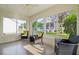 Cozy sunroom with ample natural light, featuring comfortable seating arrangements and views of the surrounding landscape at 9345 Se 171St Le Flore Ln, The Villages, FL 32162
