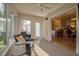 Bright sunroom with large windows, comfortable seating, and easy access to the house and backyard at 9345 Se 171St Le Flore Ln, The Villages, FL 32162