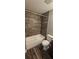 Well-lit bathroom with a bathtub, shower, tiled walls, and modern fixtures at 1318 Herschell St, Lakeland, FL 33815