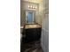 Bathroom with a dark vanity, contemporary fixtures and a toilet at 1318 Herschell St, Lakeland, FL 33815